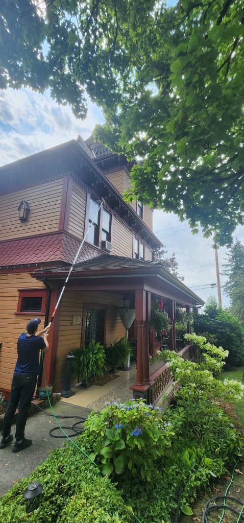 A man with a long hose cleaning a house | JF Services | JF Janitorial Services | JF Cleaning Services